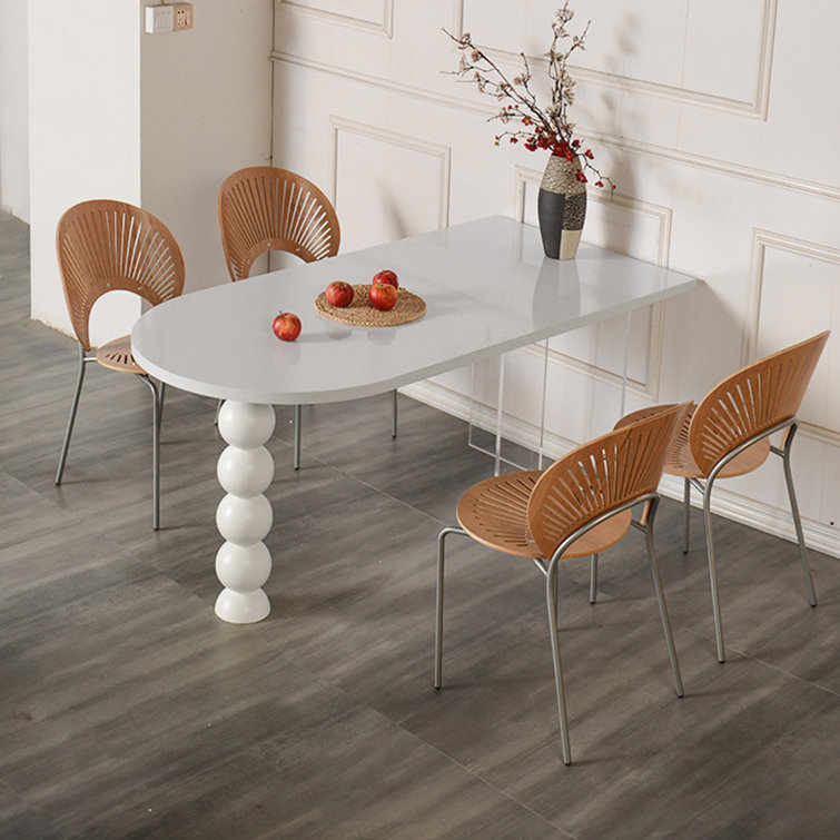 Orren Ellis Creamy wind semi oval dining table household against